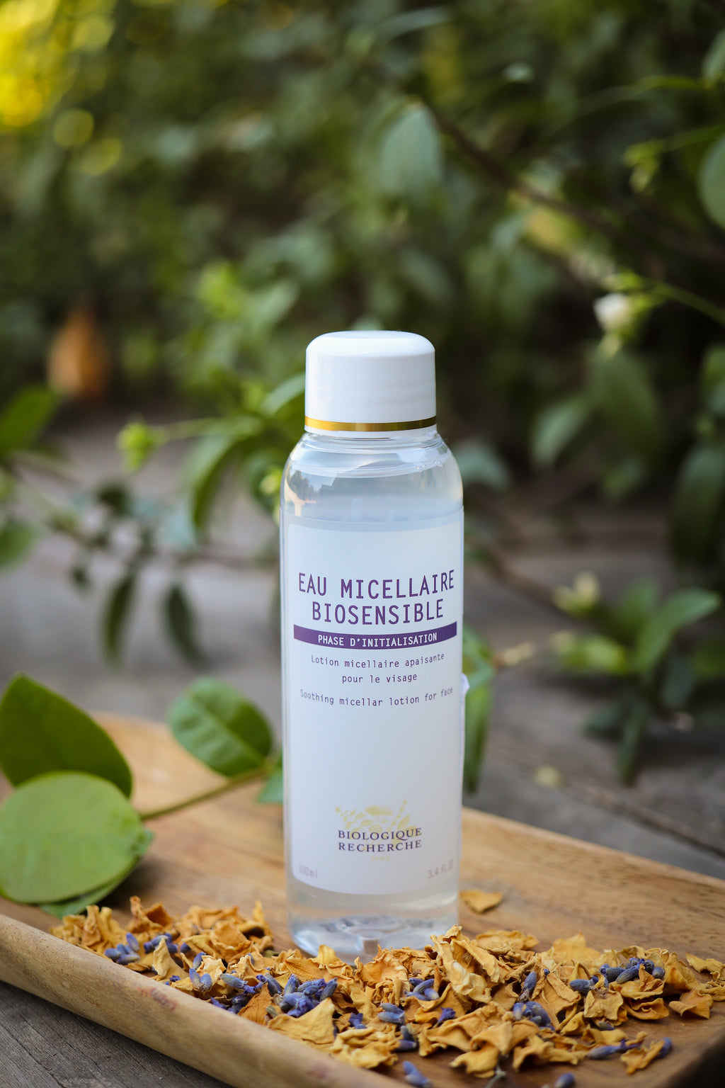  micellar water for sensitive skin exposed on a brown board with a green background